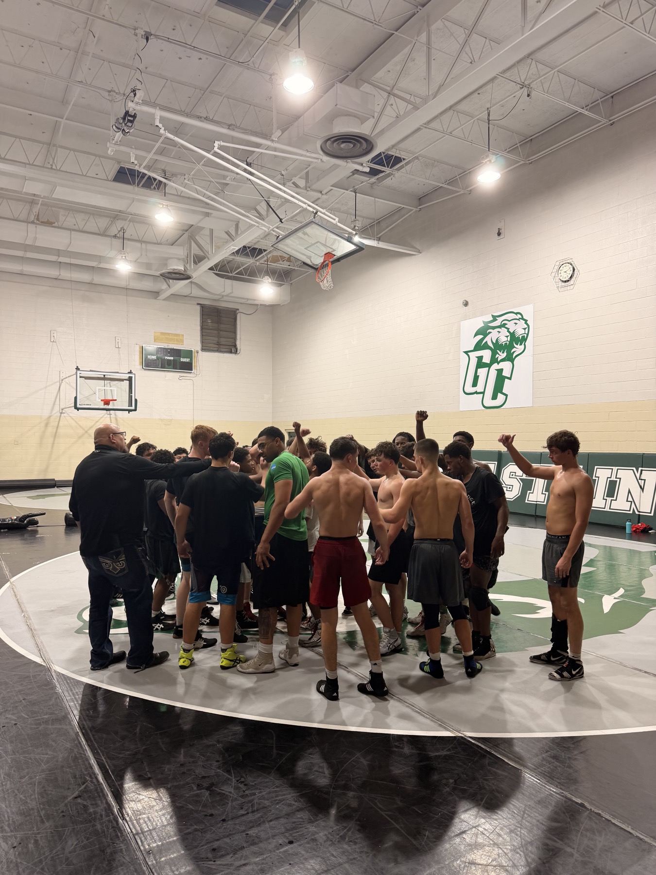 Greensboro RTC wrestlers closing practice in a team huddle