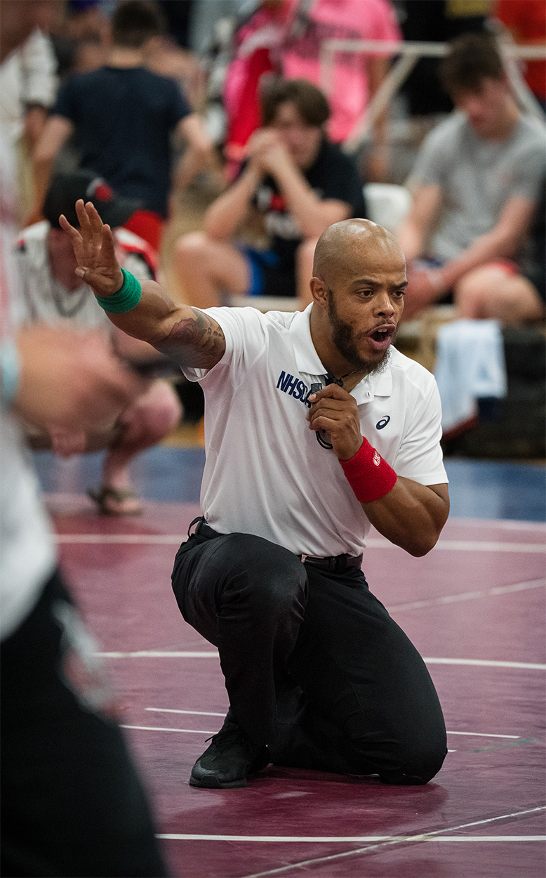 Jonathan Sutton officiating a wrestling match
