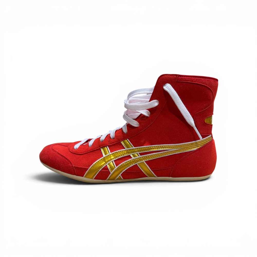 A red suede Asics Ex-Eo wrestling shoe with gold and white stripes, photographed from the side