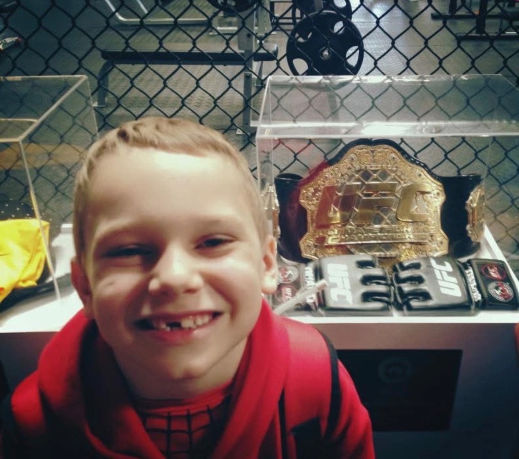 Caden Perry with a championship belt display