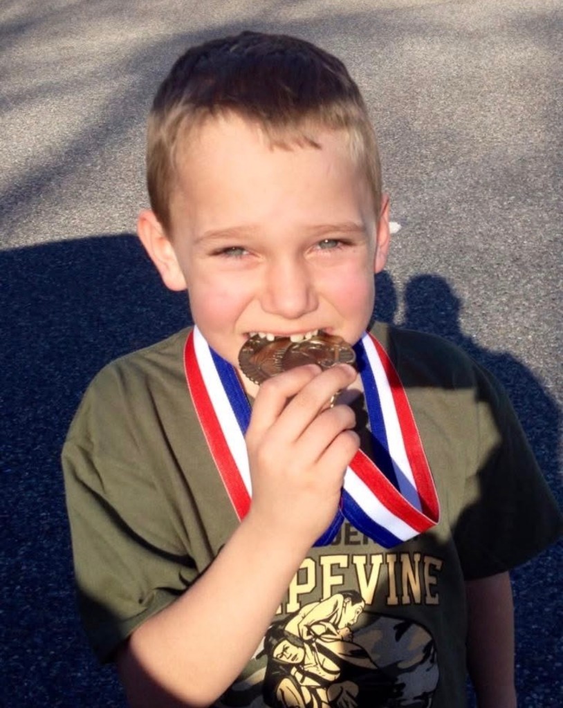 Caden Perry celebrating with a wrestling medal
